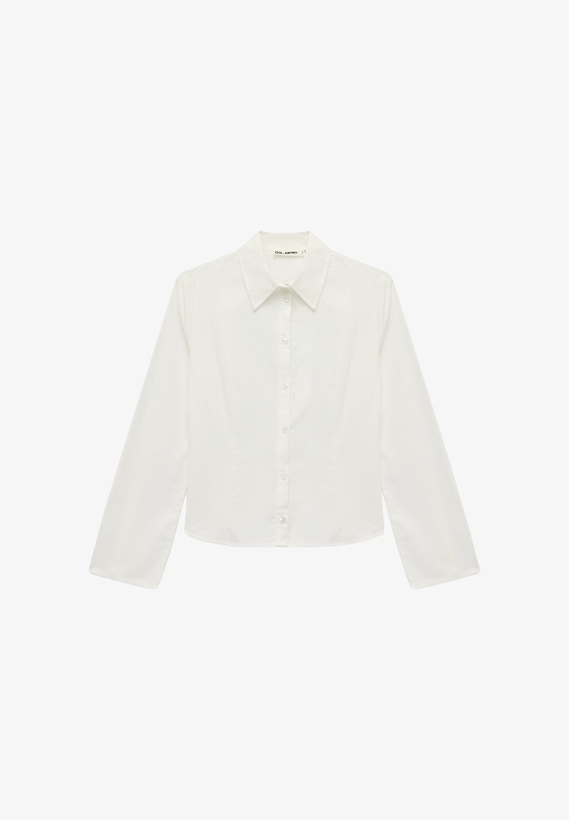White long-sleeve button-up shirt made of crisp cotton. Features a classic pointed collar and straight cut with a slight waist fit.