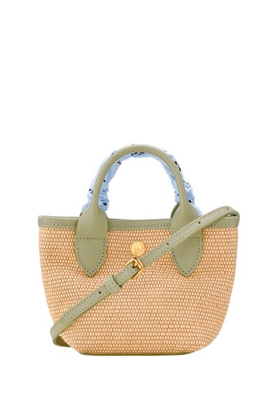 Small woven handbag with light green leather trim, top handles wrapped in a blue patterned scarf, and an adjustable shoulder strap across the front.