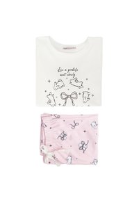 Weißes Baumwoll-T-Shirt mit schwarzen Illustrationen von Kaninchen und einer Schleife, kombiniert mit rosa Schlafshorts, die mit schwarzen Mustern von Kaninchen und Schleifen verziert sind.