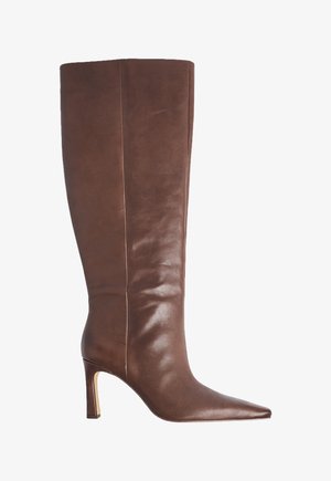 Bota alta de cuero marrón para mujer con punta puntiaguda y tacón medio delgado, acabado liso y detalle de costura lateral.