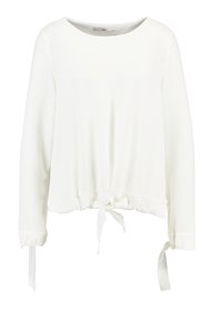 Top blanco de manga larga con cuello redondo y detalle de lazo en la cintura. Textura suave, diseño sin adornos y ajuste ligeramente holgado.