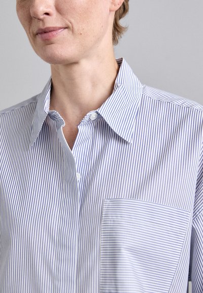 Striped button-up shirt in white and blue, featuring a collar, a chest pocket, and a smooth texture. Vertical stripes are evenly spaced.