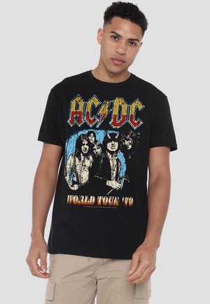 Black cotton T-shirt featuring a vintage AC/DC graphic with band members and "World Tour '79" text in red and blue. Short sleeves, relaxed fit.
