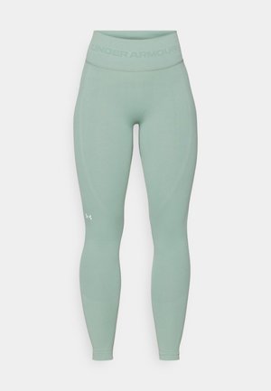 Helle grüne Leggings mit figurbetontem Design. Sie verfügen über einen breiten, strukturierten Bund und ein dezentes Under Armour-Logo an der Unterseite des Beins.