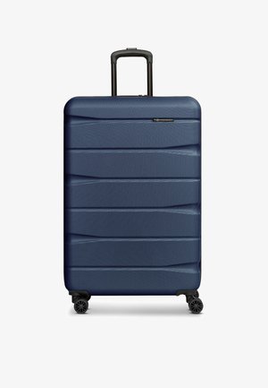 Valigia rigida blu navy con superficie testurizzata, manico telescopico e quattro ruote girevoli.