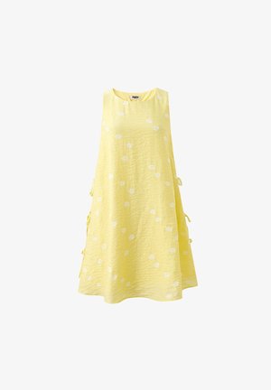 Robe jaune sans manches en ligne A avec pois blancs et liens sur les côtés, fabriquée en tissu texturé.