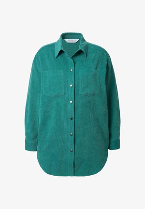 Tummansininen corduroy-paita, jossa on terävä kaulus, etunappisulku ja kaksi rintataskua. Paitassa on pitkät hihat ja pyöristetty helma.