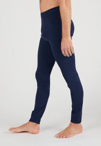 Marineblaue Leggings aus weichem, dehnbarem Material. Sie haben einen hohen Bund, schmale Beine und eine glatte Textur.