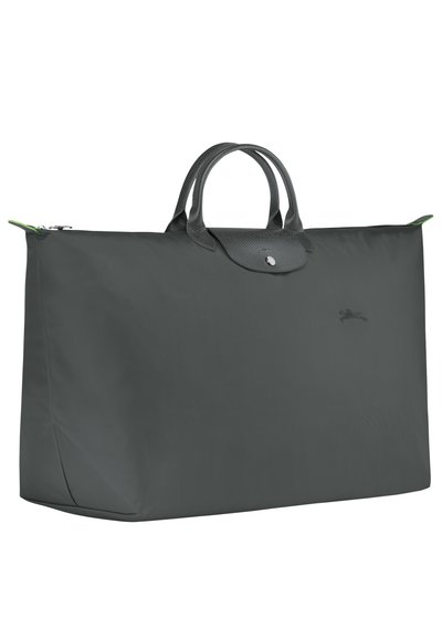 Large gray nylon tote bag with textured leather handles and closure, featuring a subtle logo. Green accent at zipper. Spacious design.