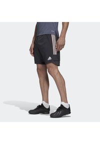 Czarne spodenki sportowe z trzema różowymi pionowymi paskami, z logo Adidas. Wykonane z lekkiego materiału, o luźnym kroju.