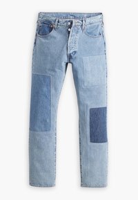 Světle modré džíny z denimu s tmavším modrým výšivkovým vzorem na obou nohavicích, knoflíkový zapínání a přední a zadní kapsy, položené na bílé pozadí.