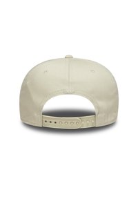 Beige baseball cap with adjustable plastic strap, smooth fabric, six-panel design, and ventilation eyelets on the back.