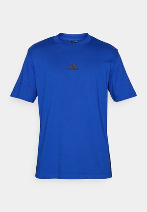 Blauwe T-shirt met korte mouwen en een ronde halslijn, met een donker logo op de borst en zwarte zijpanelen voor contrast. Zacht materiaal.