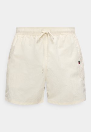 Shorts de bain couleur crème en matière légère, dotés d'une taille élastique, d'un cordon de serrage et d'une broderie de logo sur le côté.