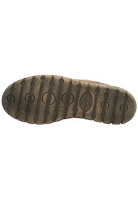 Brown rubber shoe sole with a textured surface, featuring horizontal grooves and circular indentations for grip.