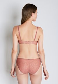 Rose-colored lace bra and matching brief set. Bra features adjustable straps and a hook closure. Briefs have a seamless design.