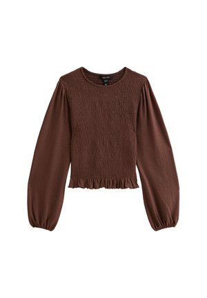 Brown smocked top with long puff sleeves, a round neckline, and a ruffled hem. Made from textured fabric with a fitted waist.