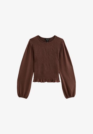 Top marrone arricciato con maniche lunghe a sbuffo, scollatura rotonda e orlo a volant. Realizzato in tessuto testurizzato con vita aderente.
