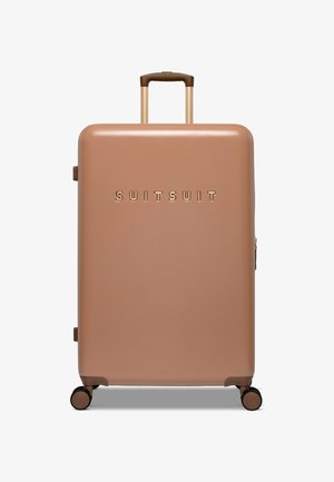 Hard-shell suitcase in matte rose gold with gold embossed "SUITSUIT" logo, a retractable brown handle, and four spinner wheels.