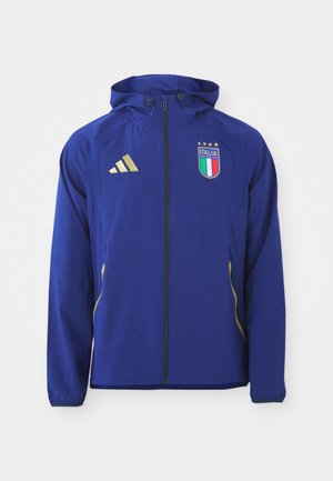 Blaue Sportjacke mit Kapuze, goldenen Akzenten und einem Italien-Emblem, ausgestattet mit einem durchgehenden Reißverschluss und langen Ärmeln aus glattem Material.