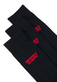 Schwarze Socken aus Baumwolle mit gerippten Bündchen; mit rotem Levi's-Logo an der Seite. Set aus drei Paaren.