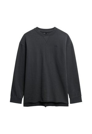 Sudadera negra de manga larga hecha de una mezcla de algodón, con escote redondo, puños acanalados y un sutil logo de la marca en el pecho. Textura suave.