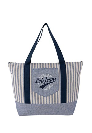 Bolsa tote de rayas azul y crema con asas azul oscuro, un bolsillo delantero con un logo circular y cierre con cremallera.