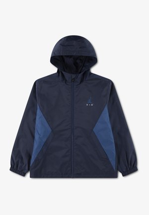 Veste à capuche bleu foncé avec fermeture éclair sur le devant, panneaux latéraux bleu clair, poignets élastiques, et un petit logo bleu Air Jordan sur le côté gauche de la poitrine.