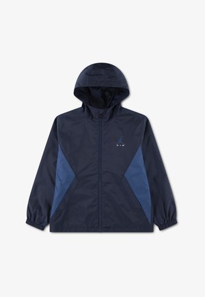 Mørkeblå hættetrøje med lynlåslukning foran, lyseblå sidepaneler, elastiske manchetter og et lille blåt Air Jordan-logo på venstre bryst.