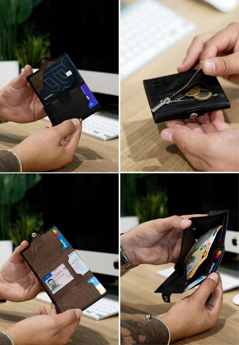 Black leather wallet with a zippered coin pocket, card slots, and a snap closure. It features a smooth texture and compact design.