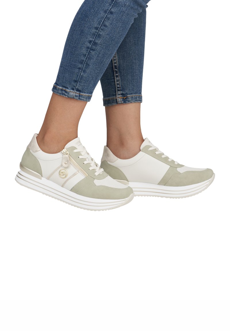 Sleek athletic shoes featuring a mix of white and light green suede and mesh, textured accents, and a zipper detail on the side.