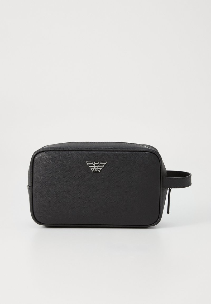 Black rectangular cosmetic bag with a textured finish, featuring a silver logo on the front and a side handle. Zipper closure on top.