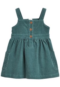 Sukienka z kordurowej tkaniny w odcieniu teal, z regulowanymi ramiączkami, przodem zapinanym na guziki w kolorze drewna oraz dwiema bocznymi kieszeniami. Teksturowana tkanina z prążkowanym wzorem.