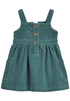 Corduroy kjole i teal, med justerbare stropper, en knaplukning foran med træknapper, og to sidelommer. Tekstureret stof med ribbet mønster.