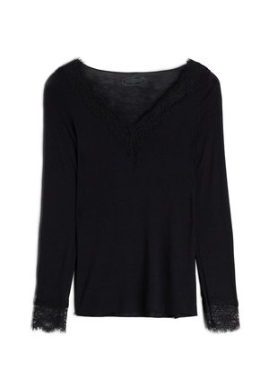 Haut noir à manches longues pour femmes avec col en V et bordure en dentelle sur l'encolure et les poignets des manches, posé à plat sur un fond blanc.