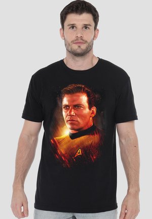 Black cotton t-shirt featuring a graphic print of a character in a yellow uniform with a vibrant red and orange background. Short sleeves.