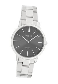 Montre-bracelet en acier inoxydable argenté avec un cadran rond gris, des index horaires minimalistes et un bracelet poli.
