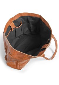 Brown leather tote bag with a spacious black fabric interior, featuring side pockets and smooth texture, highlighted by subtle stitching.