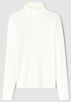 Haut à manches longues à col roulé côtelé blanc avec une silhouette ajustée et des fentes sur les côtés à l'ourlet. Texture douce et design sans couture.