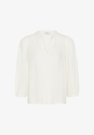 Blouse blanche à manches longues avec manches bouffantes froncées et décolleté en V avec petit col montant.