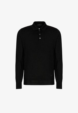 Polo shirt nero a maniche lunghe realizzato in un morbido tessuto a maglia. Caratterizzato da un colletto classico, un'apertura con tre bottoni e un discreto dettaglio del logo sull'orlo.