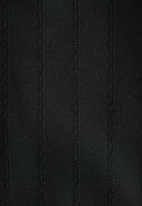 Black fabric with vertical stripes, featuring a textured weave and contrasting stitching. The surface appears smooth and durable.