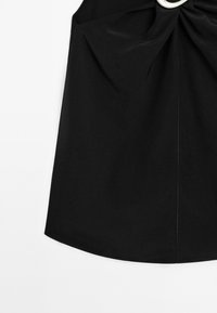 Il vestito nero presenta un corpetto aderente, tessuto arricciato in vita e un accento metallico circolare. Tessuto liscio con orlo pulito.