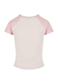 Short-sleeve t-shirt with a pink raglan design. Main body is off-white, smooth texture, rounded neckline, and stitched hems.