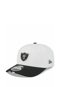 White and black Raiders baseball cap with team shield logo on front and New Era logo on side, curved black brim with sticker label.