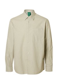 Lys beige skjorte med rutemønster laget av bomull. Har knappet ned krage, brystlomme og grønn merkelapp på nakken. Langermet.