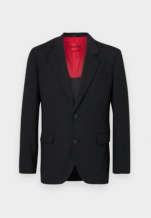 Black blazer made of smooth fabric, featuring a red lining, two front pockets, and two buttons. Notched lapels add structured detail.