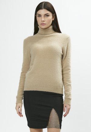 Beige turtleneck sweater with a soft, fluffy texture. Paired with a black pencil skirt featuring a side slit and mesh detail at the hem.
