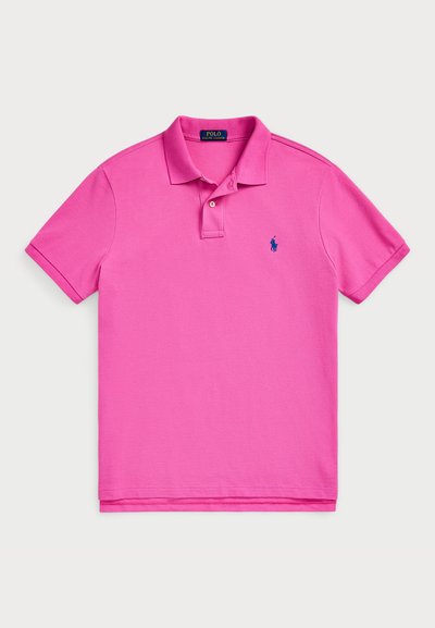 Pink polo shirt made of cotton, featuring a ribbed collar, short sleeves, and a small blue logo on the chest. Classic fit design.