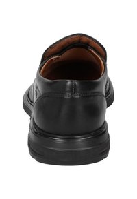 Black leather shoe with a smooth surface, a low heel, and brown interior lining. Features a rounded toe and minimal stitching detail.